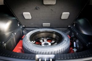 remove the spare tire and any tools with it